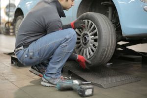 Mechanic installing a car tyre in an auto workshop